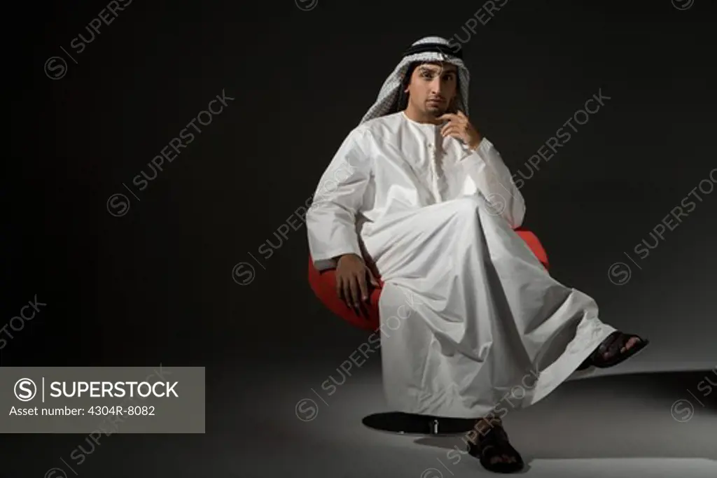 Young man sitting on chair, portrait