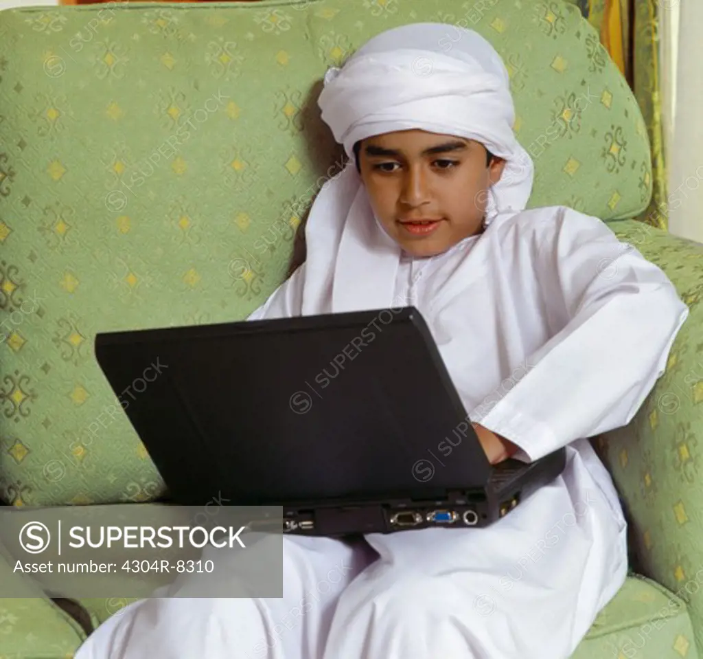 Arab boy busy on his computer