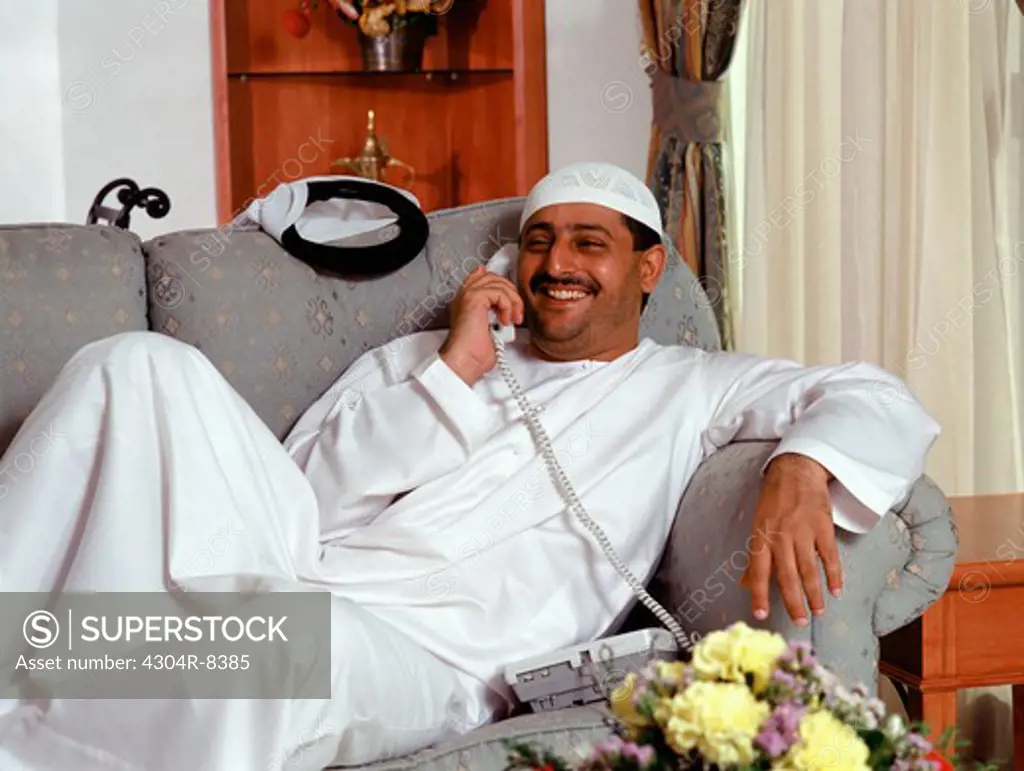 Arab man relaxing on sofa at home