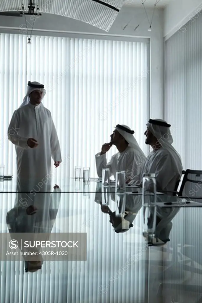 Three arab businessmen having a meeting in a conference room.