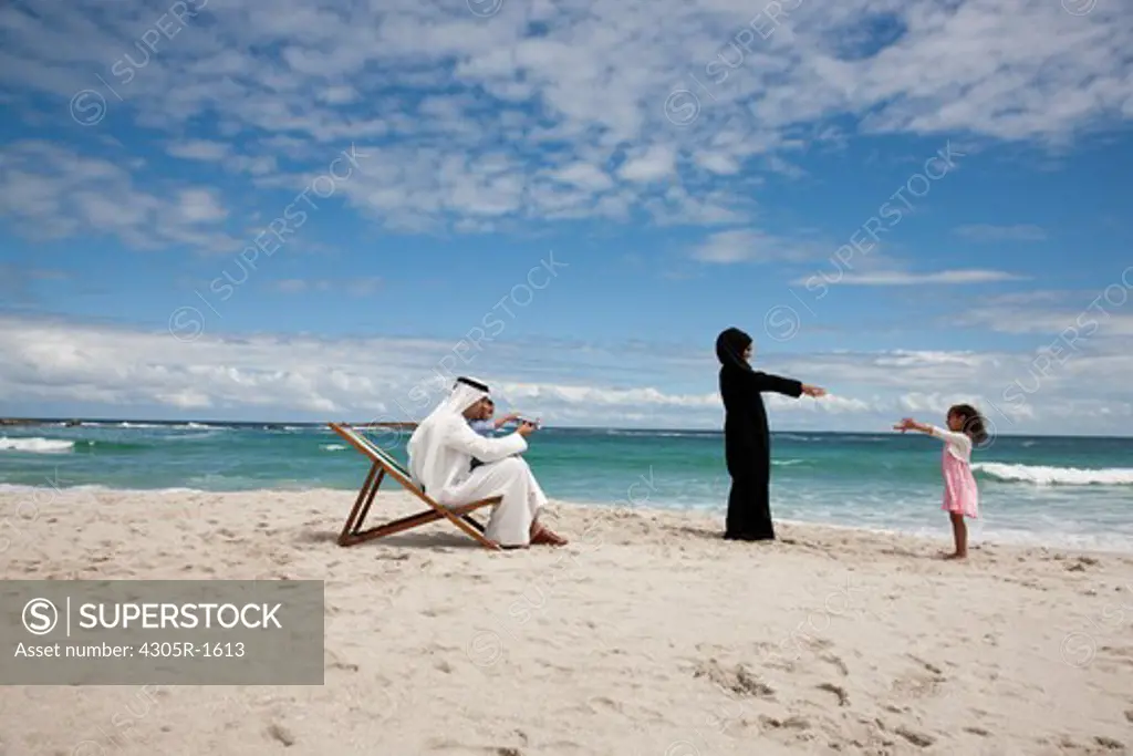 Arab family playing together at the beach.