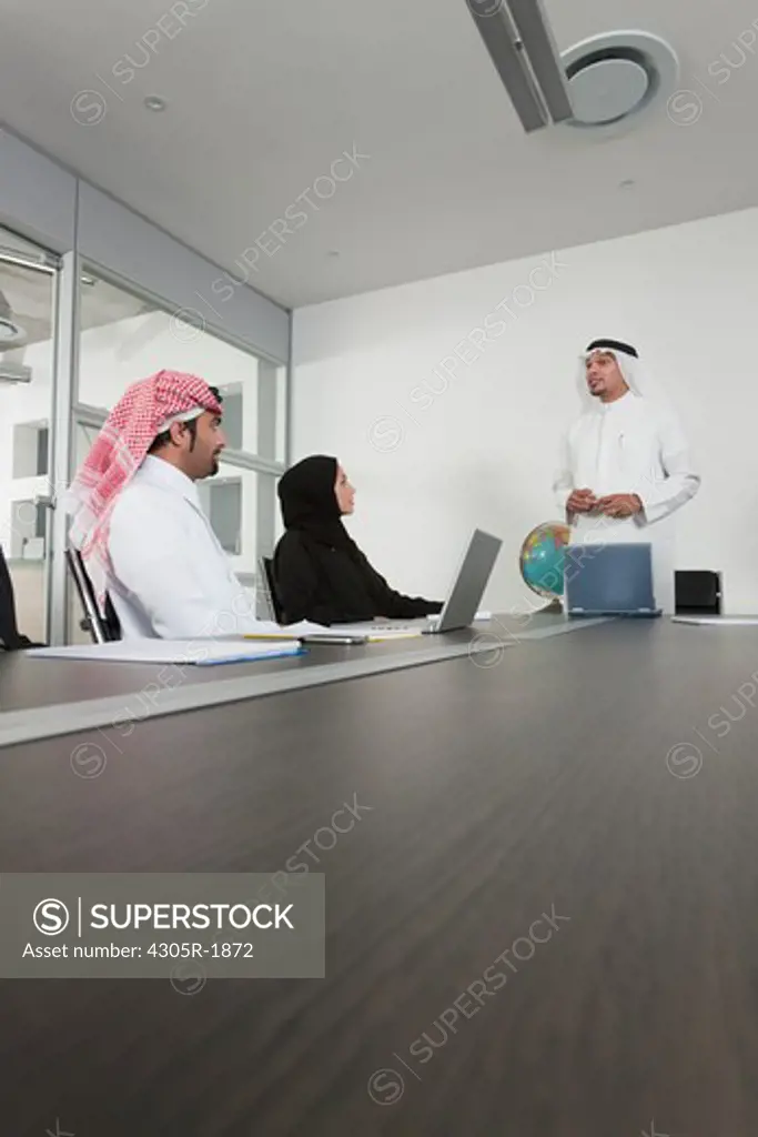 Three arab business people having meeting in office.
