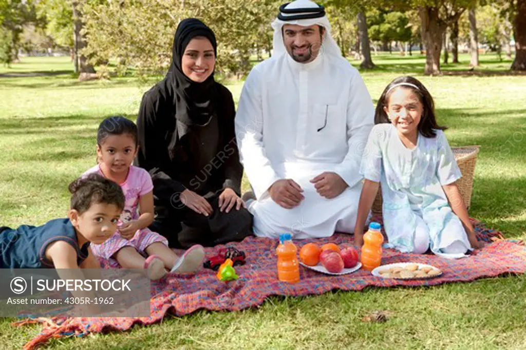 Portrait of arab family picnic in the park.