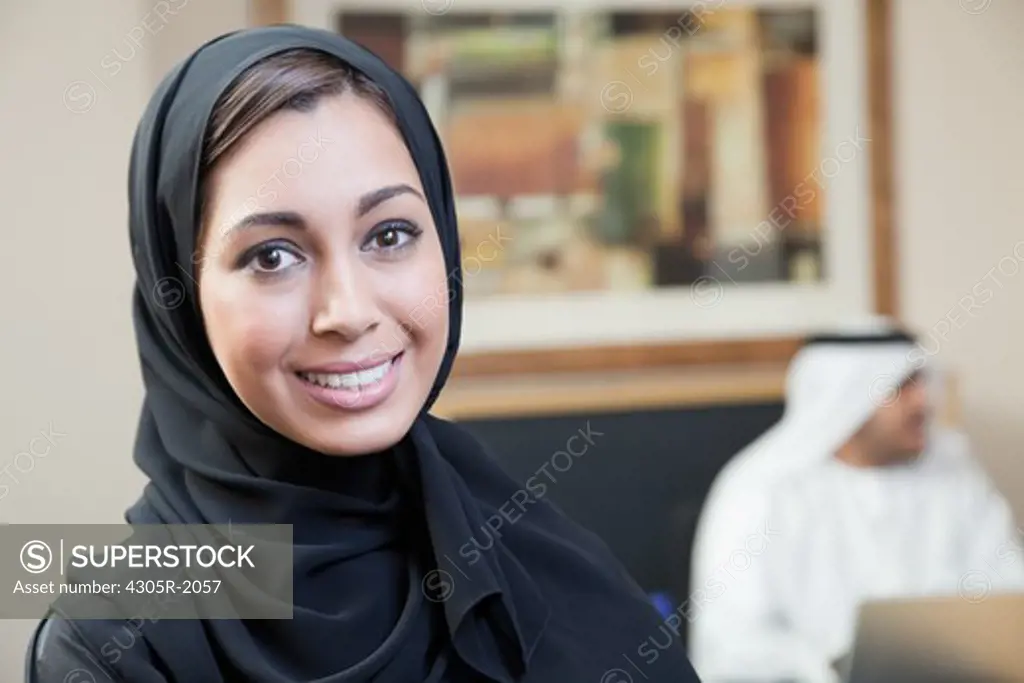 Portrait of arab businesswoman in meeting, smiling.