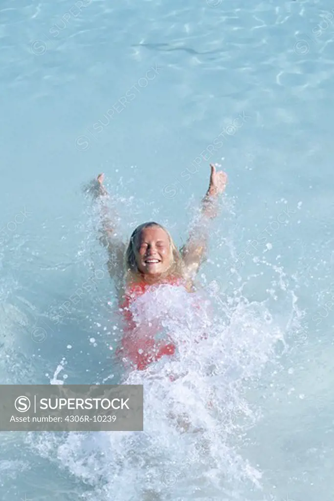 A girl in bathing suit floating on water.