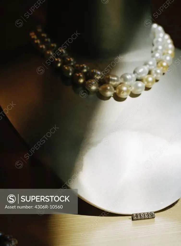 A pearl necklace in a shopwindow.