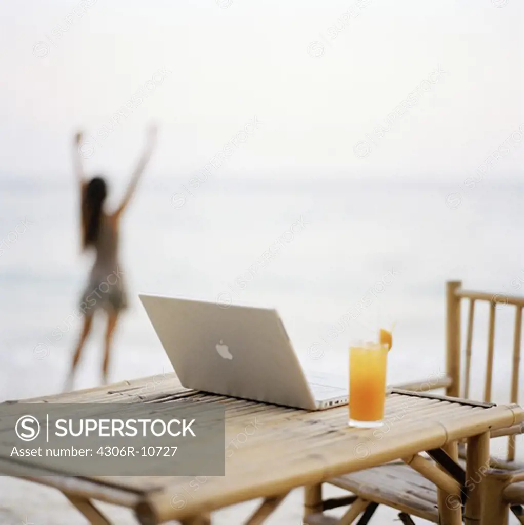 A laptop on a table down by the beach, Thailand.