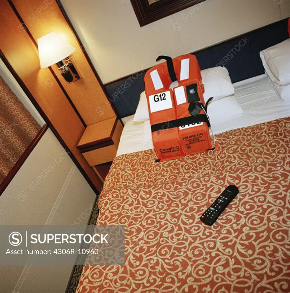 Lifevest on a bed in a cabin on a cruise liner