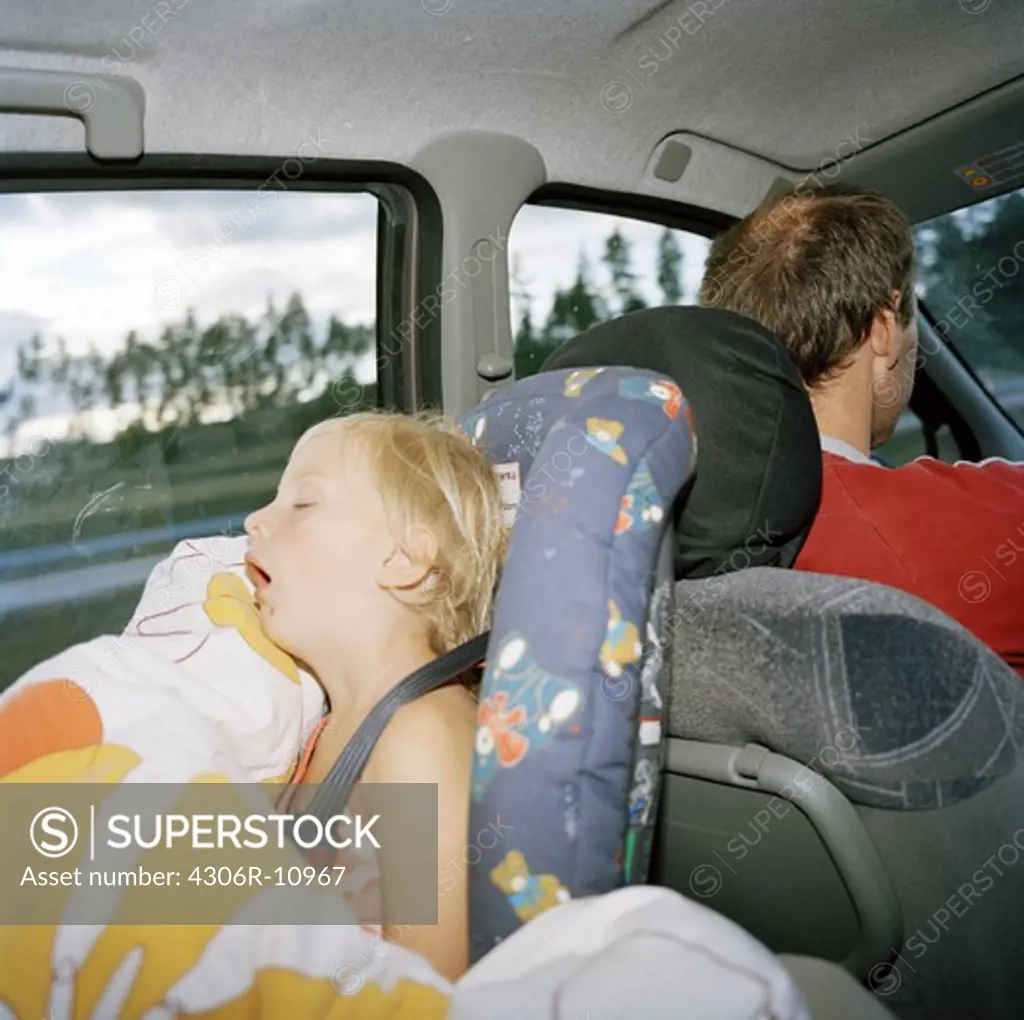 Girl sleeping in a car safety-seat, Stockholm, Sweden.
