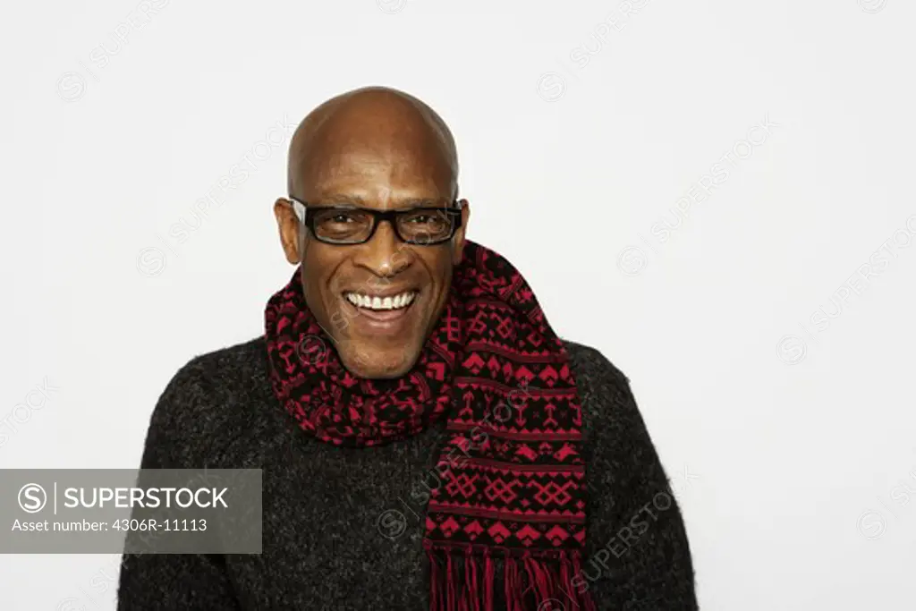 Portrait of a smiling man wearing a scarf.