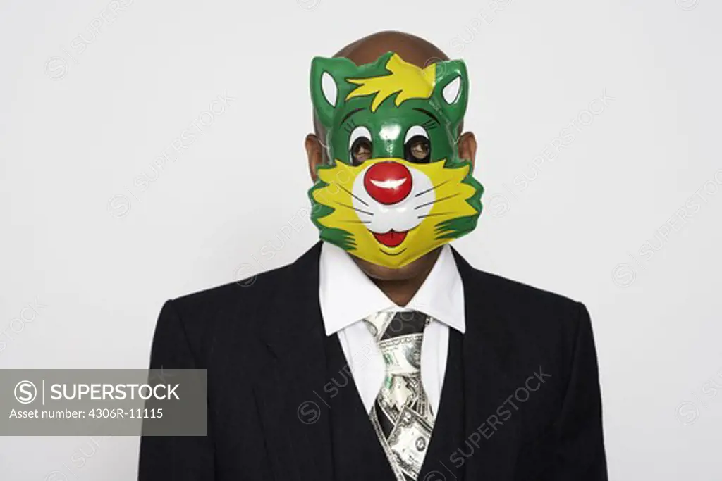 A man wearing a suit and a mask.