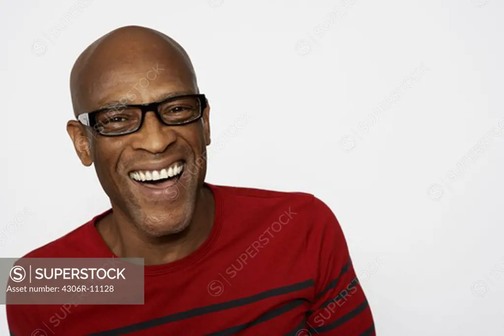 Portrait of a laughing man wearing glasses.