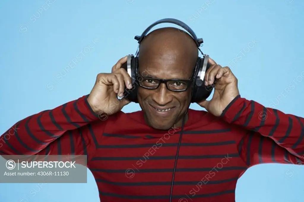 A middle aged man with headphones.