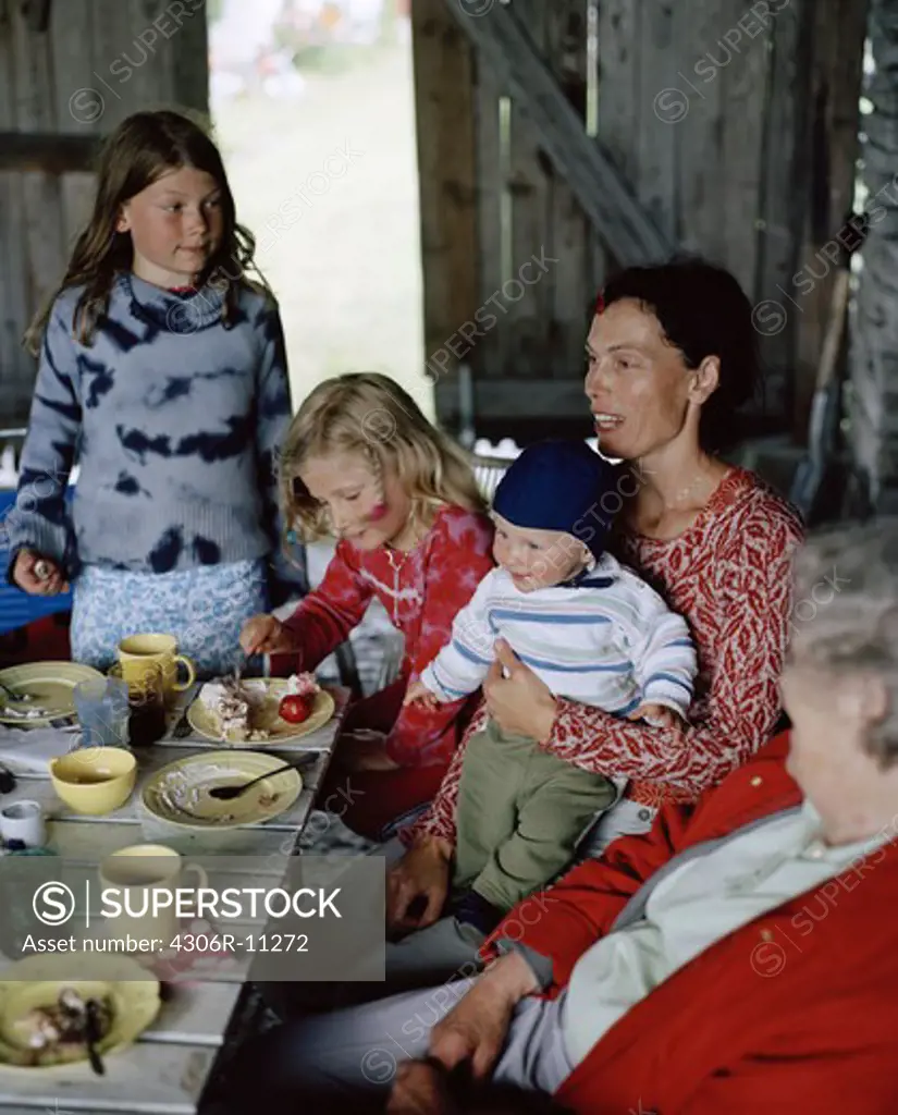 Two women and a three children having a cake, Oland, Sweden.