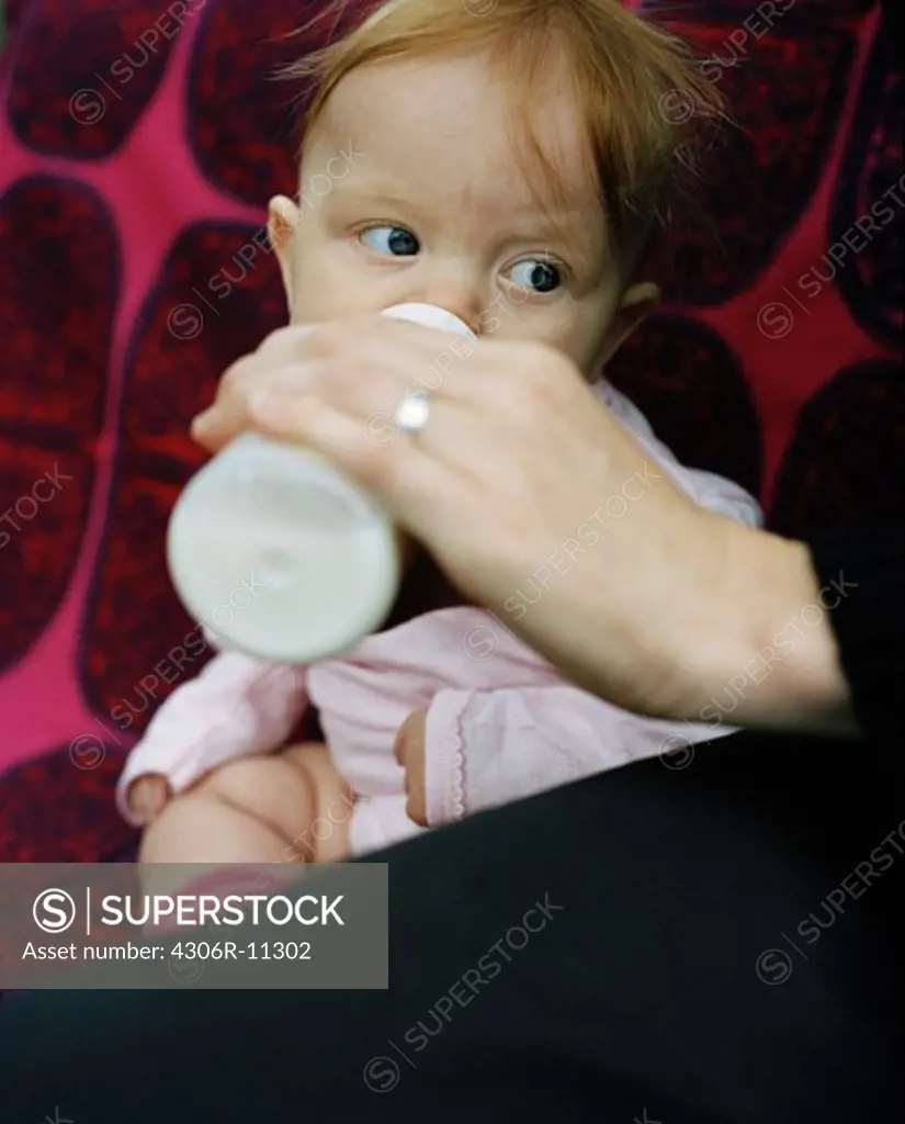 A baby is getting her bottle, Sweden.