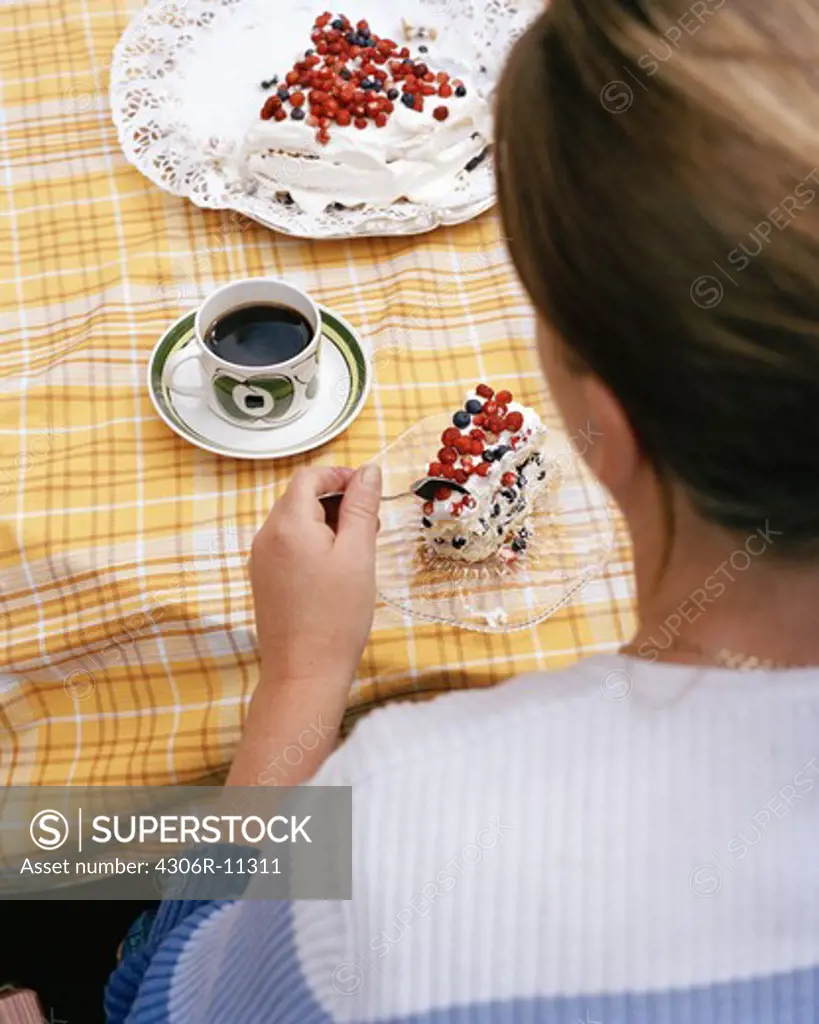 Woman eating a cake, Sweden.