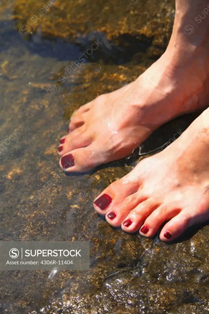 Barefooted at the waters edge, Sweden.