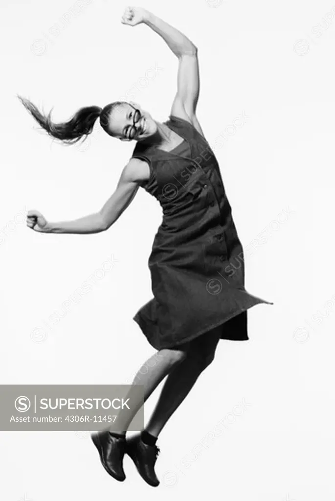 Happy woman jumping, Sweden.