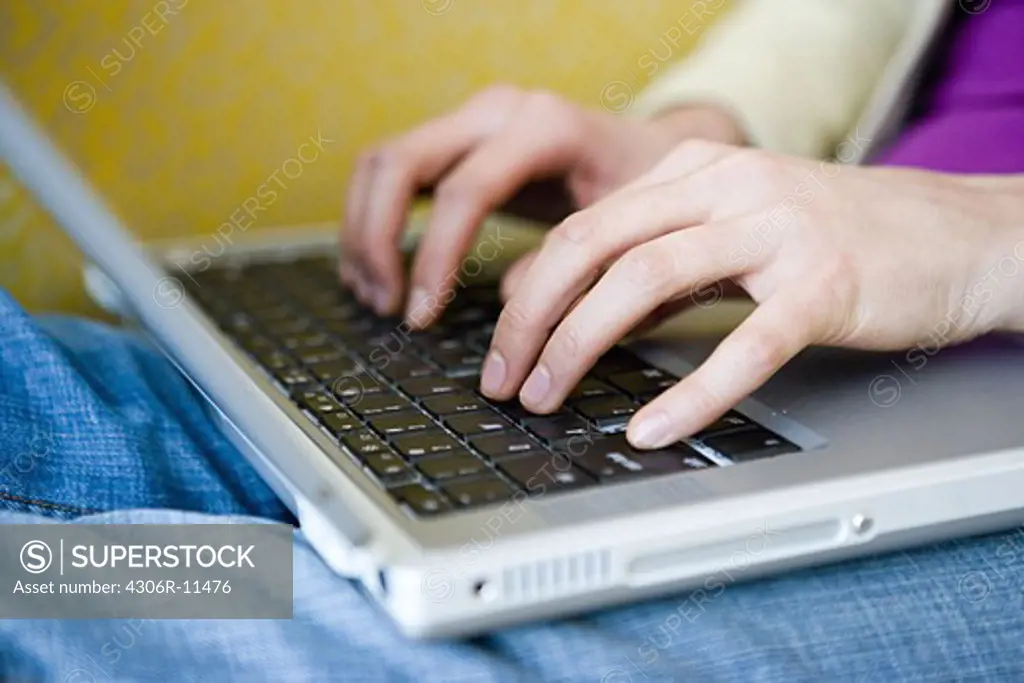 The hands of a woman with a laptop, close-up, Sweden.