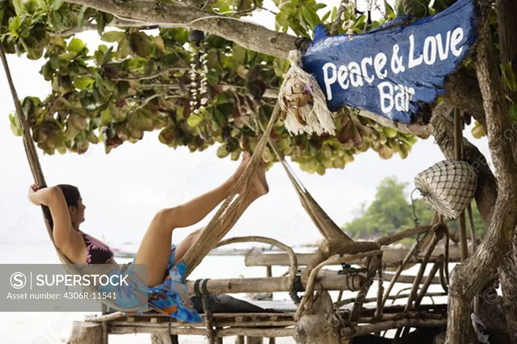 A woman in a hammock on a beach in Ko Lippe,Thailand.
