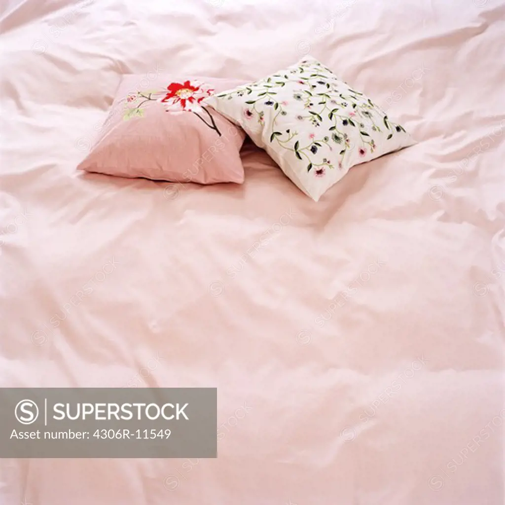 Pillows on a pink bed, Sweden.
