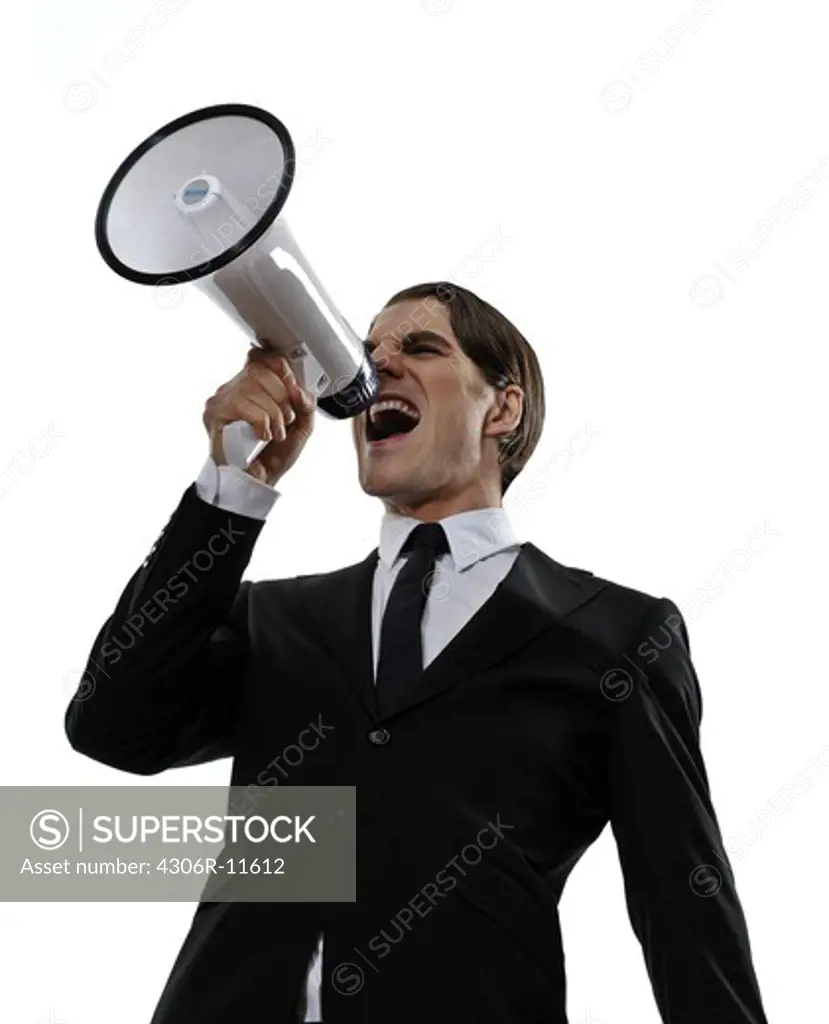 A man in a suit screaming in a megaphone, Sweden.