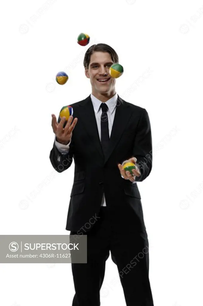 A smiling businessman  juggling, Sweden.