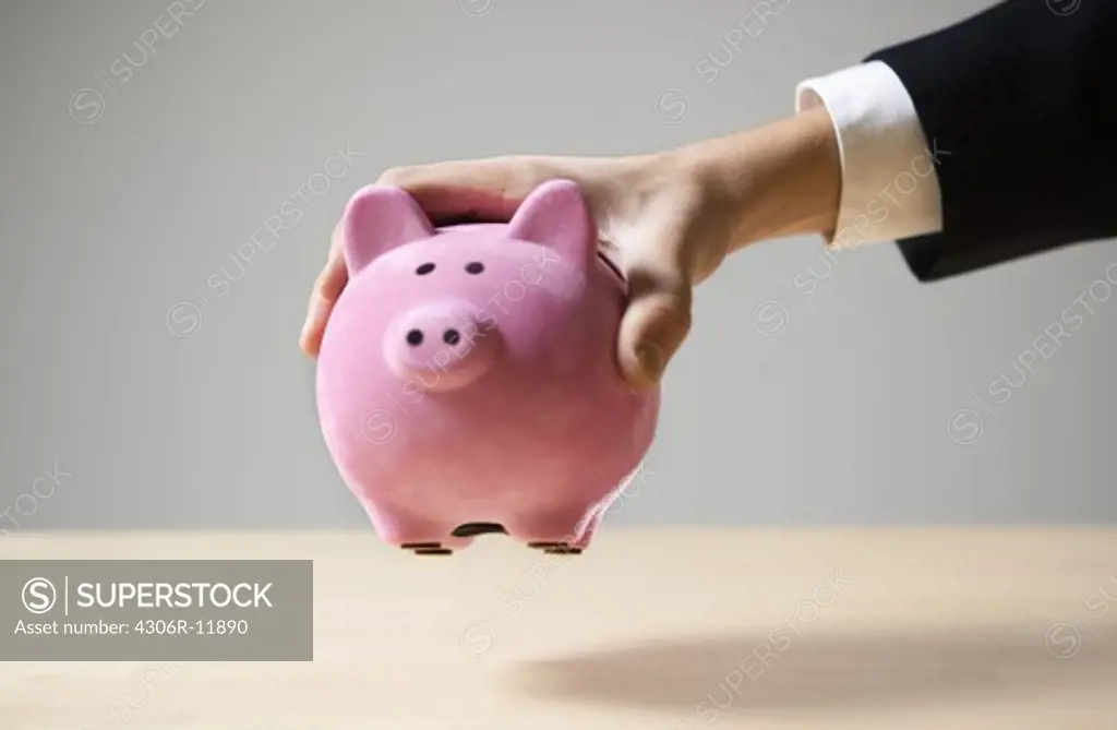 A man holding a piggy bank.
