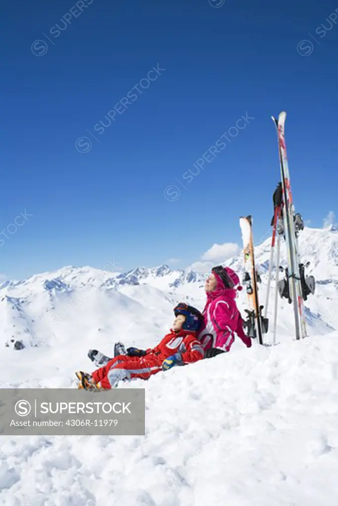 A mother and her son resting on the slopes.