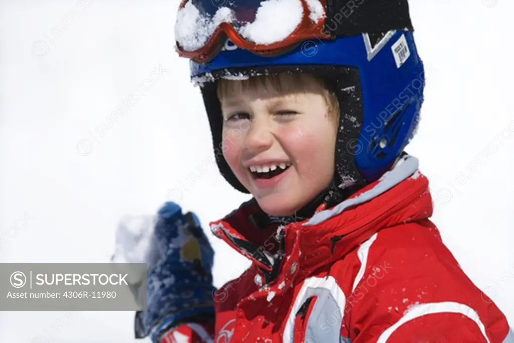 Portrait of a boy in his skiing outfit.