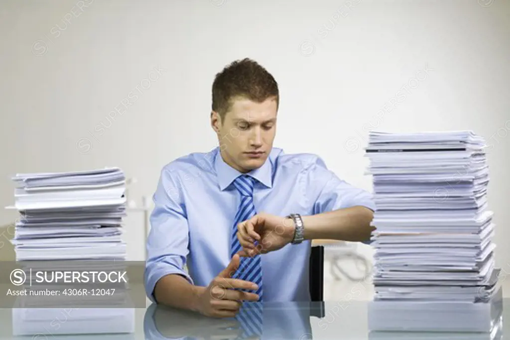 A man with a pile of paper.