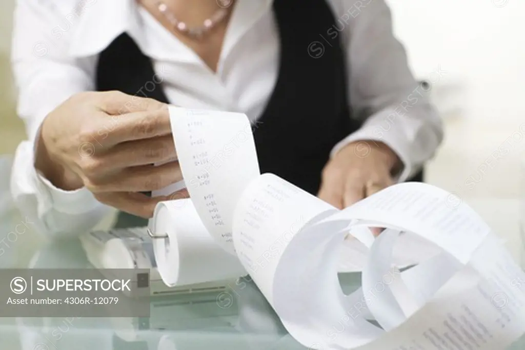 A woman doing paperwork in an office.