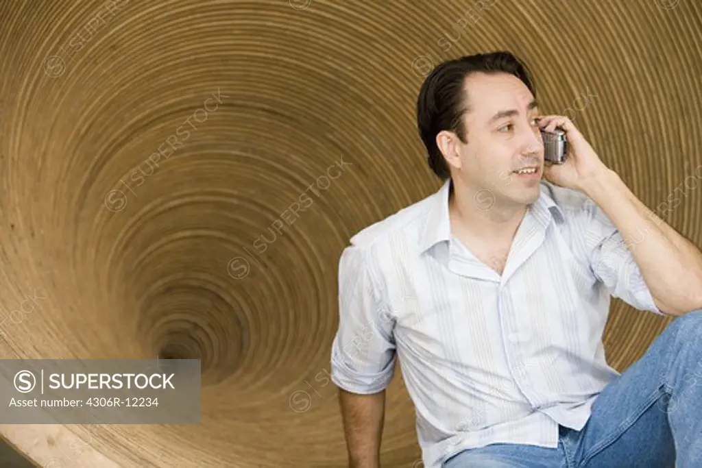 A man talking in a cellphone.