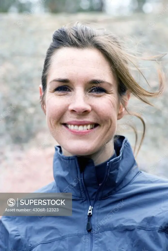 Portrait of a smiling woman in a forest, Sweden.