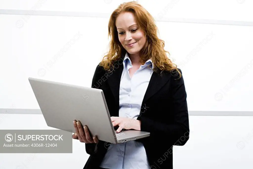 Woman using laptop, Stockholm, Sweden.