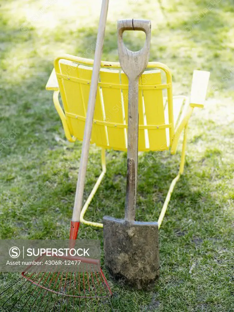 A yellow chair and garden tools, Sweden.