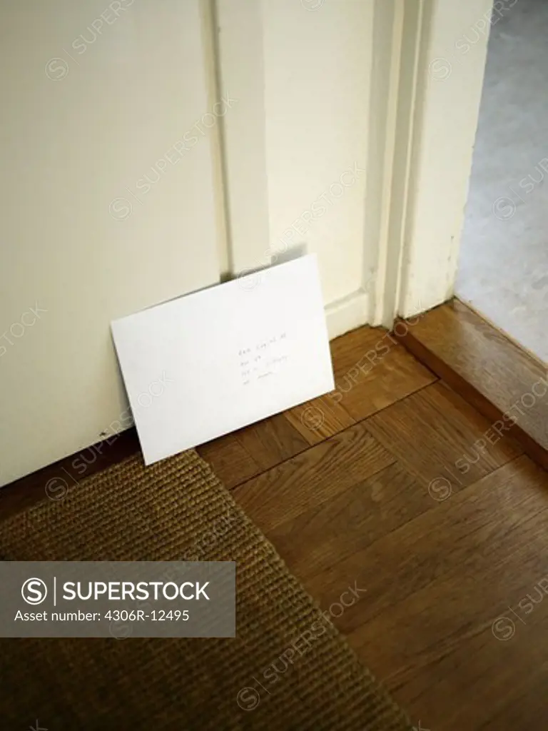 An envelope leaning towards a door, Sweden.
