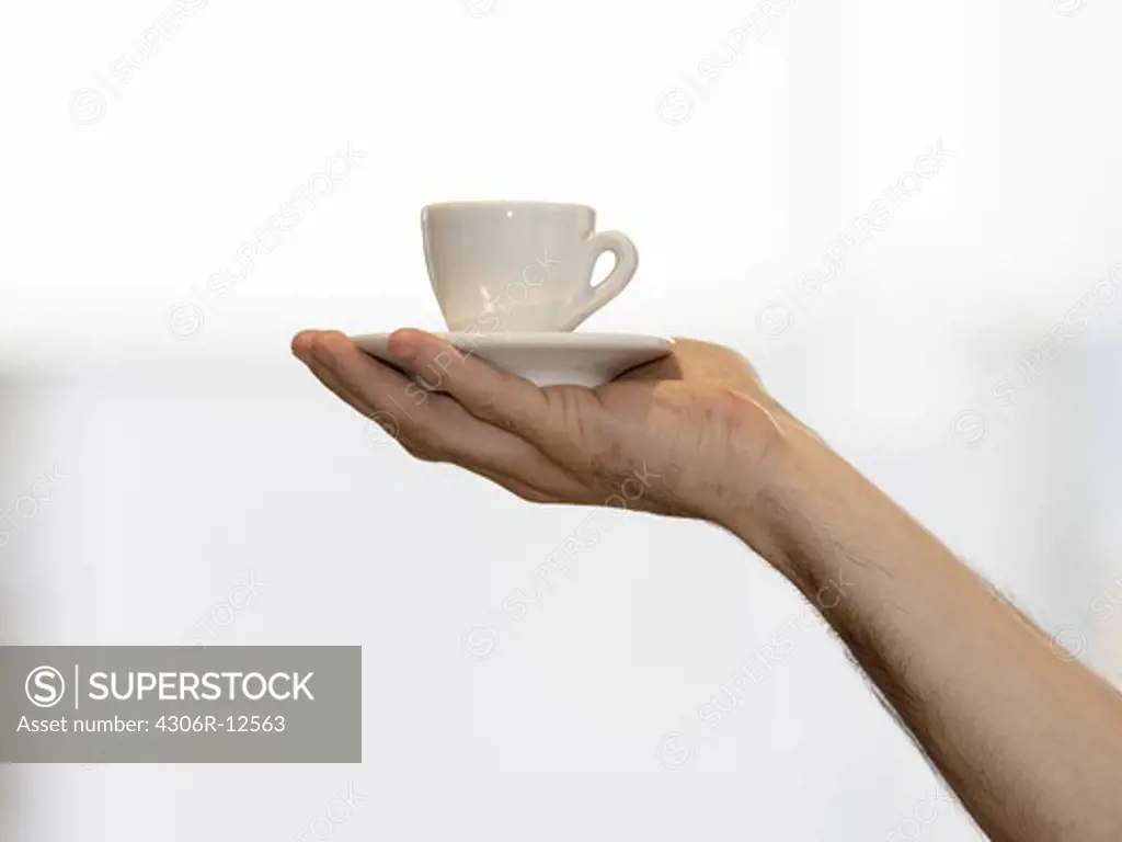 A hand holding an espresso, Sweden.