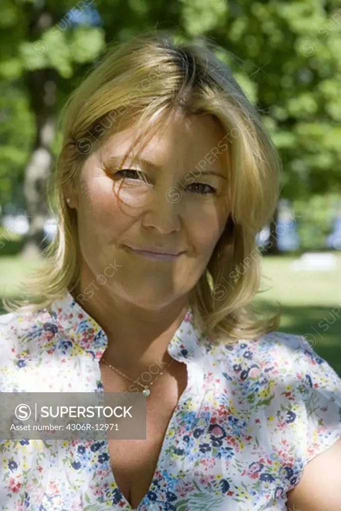 A smiling woman in a park, Stockholm, Swdeen.