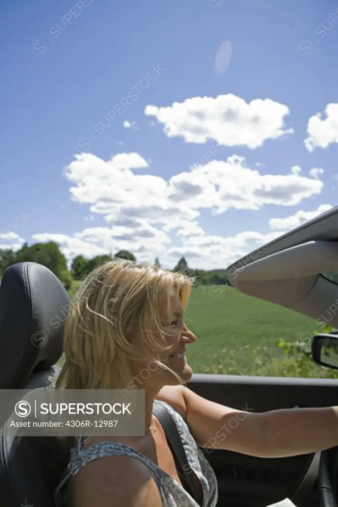 A woman driving a car, sweden.
