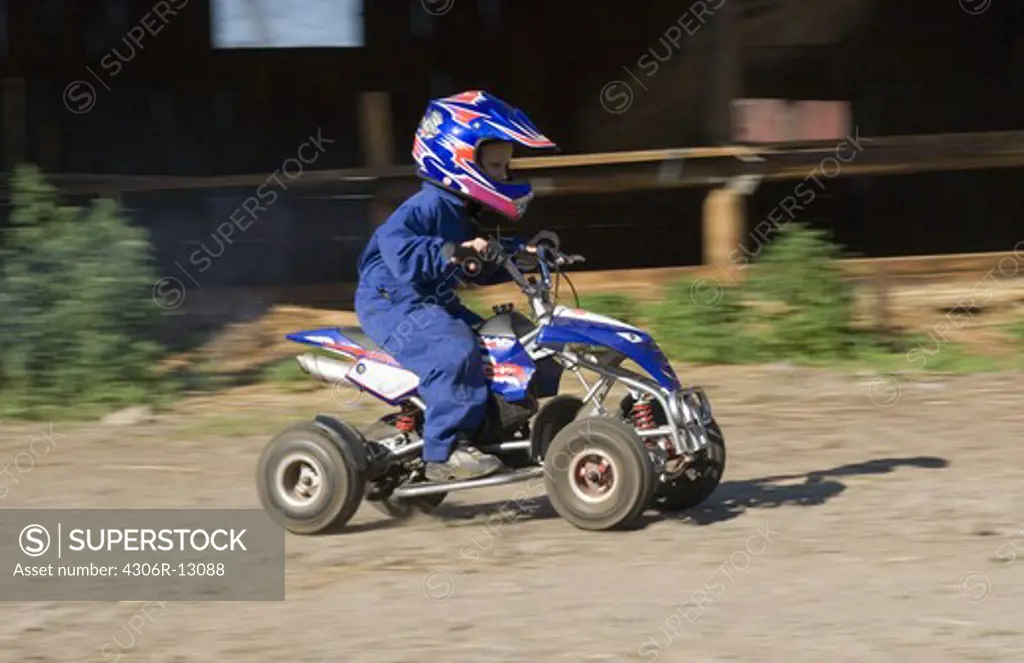 A boy on a four-wheeler, Sweden.
