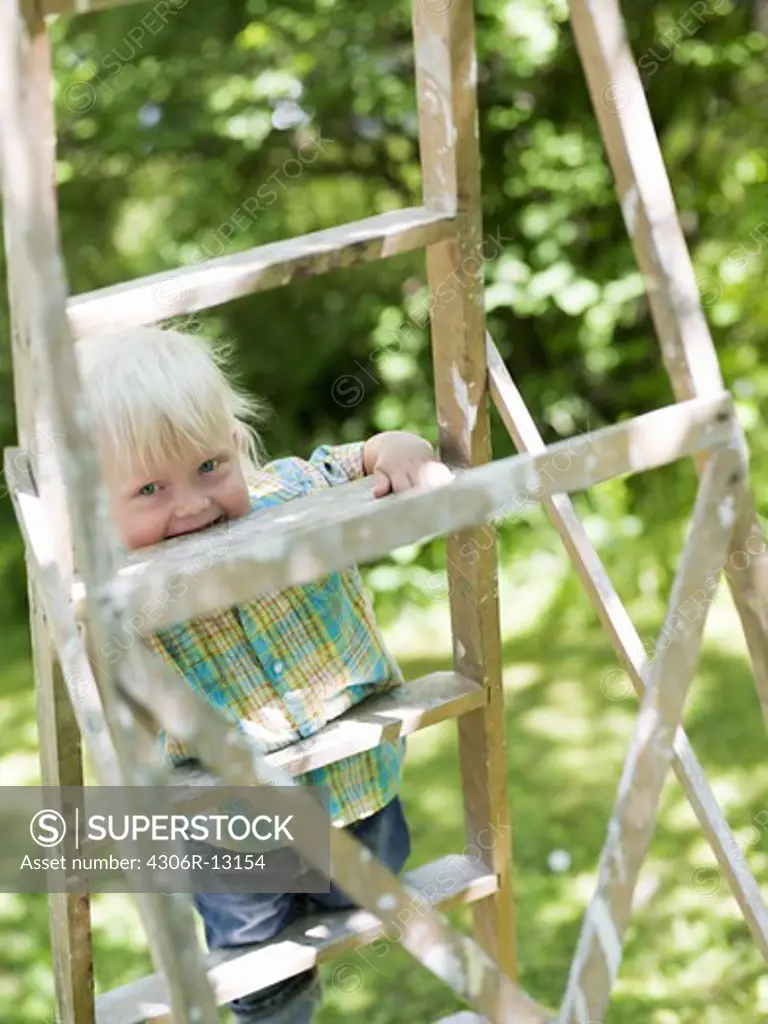 A boy climbing a ladder, Stockholm, Sweden.