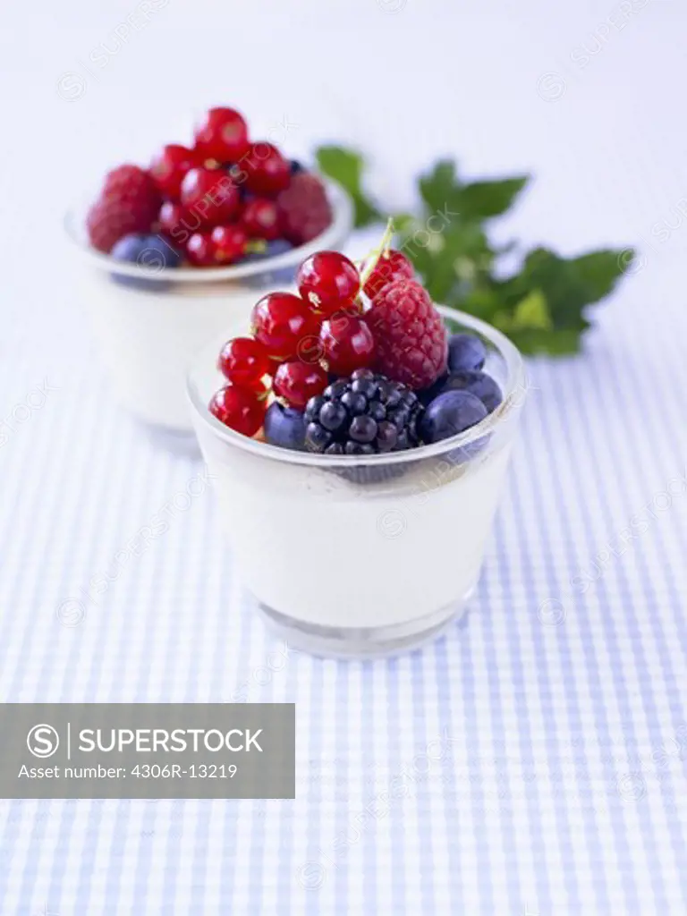 A dessert with raspberries and blueberries.