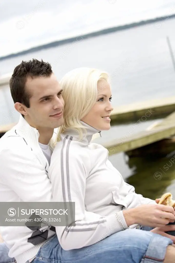 A young smiling couple embracing, Stockholm archipelago, Sweden.