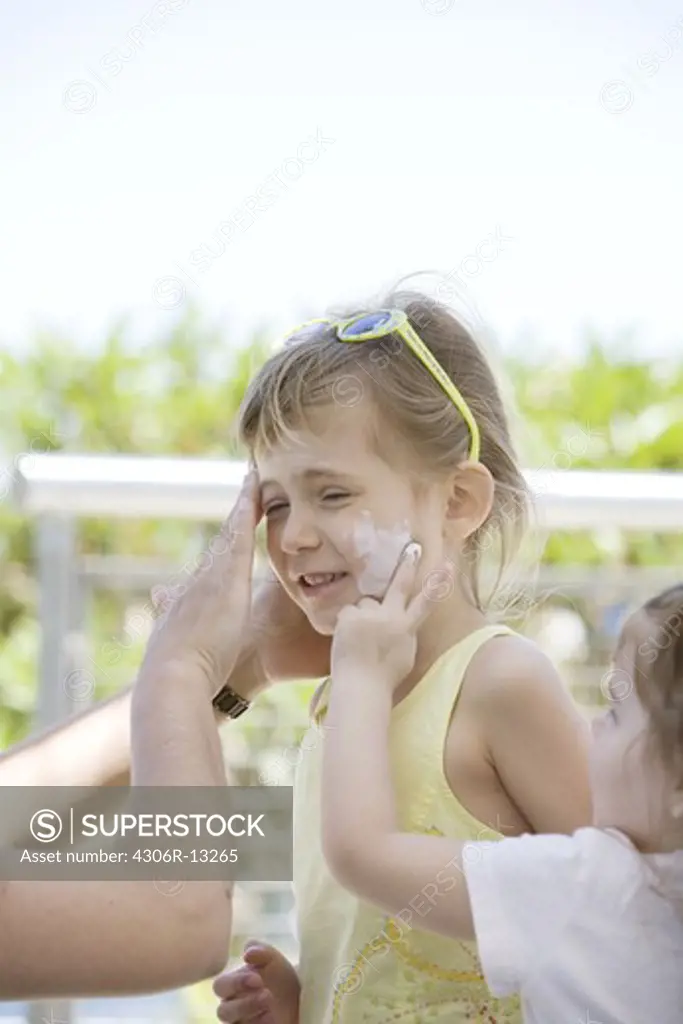 A girl with sun lotion, USA.