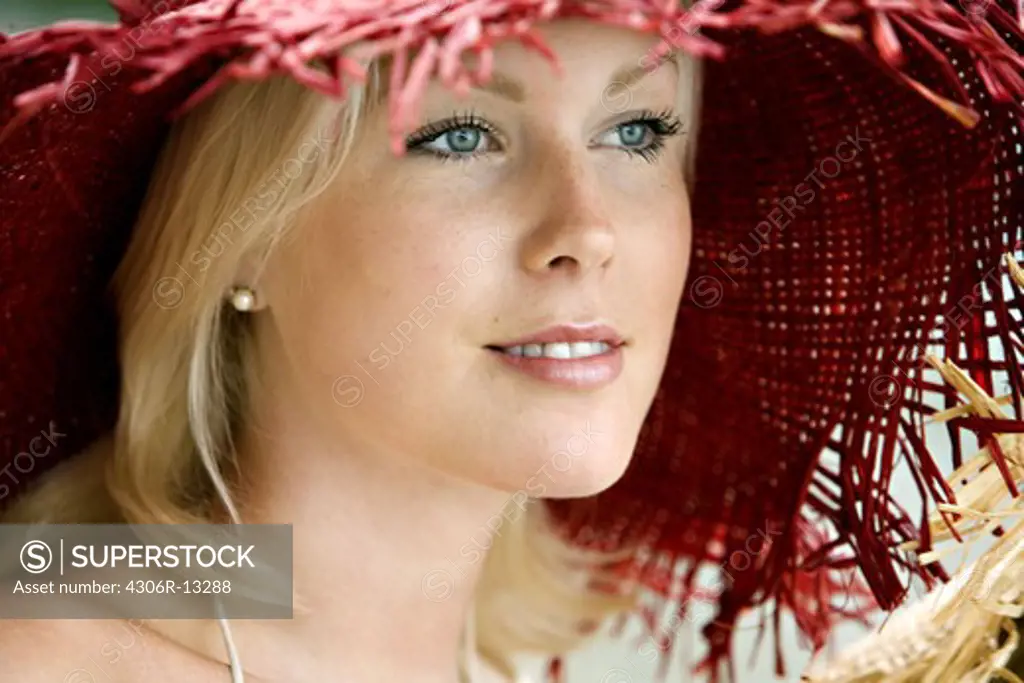 Portrait of a woman wearing a red hat, Sweden.