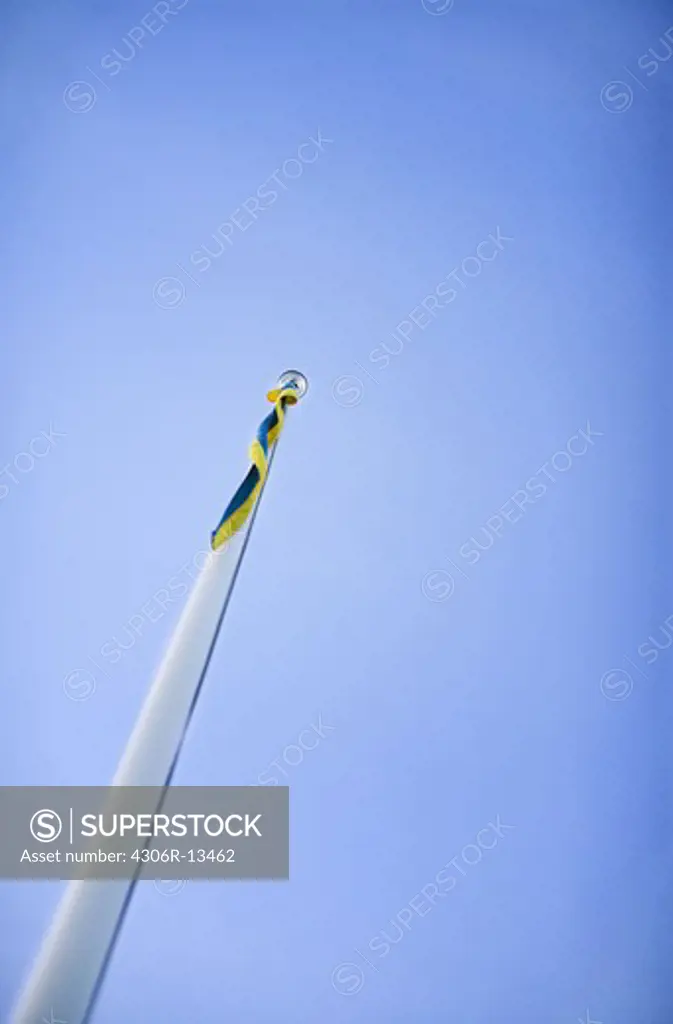 A flagstaff and blue sky, Sweden.