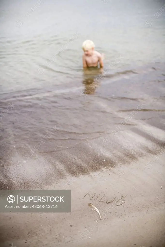 A boy bathing in the sea, Gotland, Sweden.