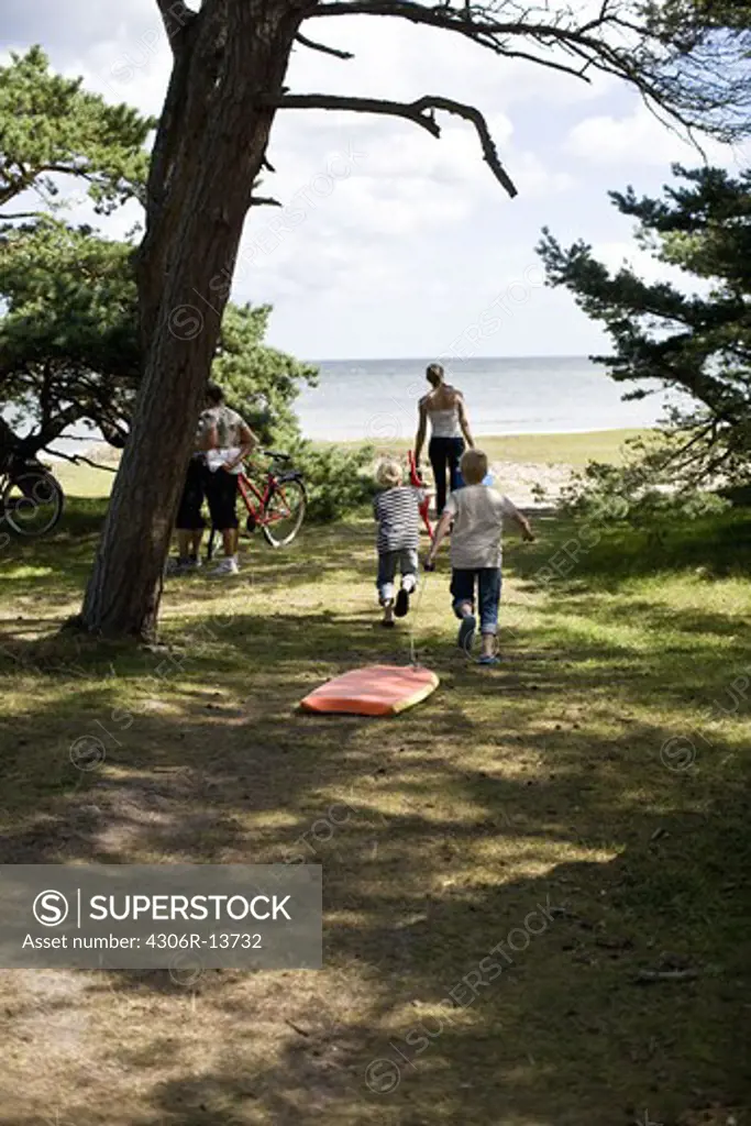 Mother and children walking toward the beach, Gotland, Sweden.