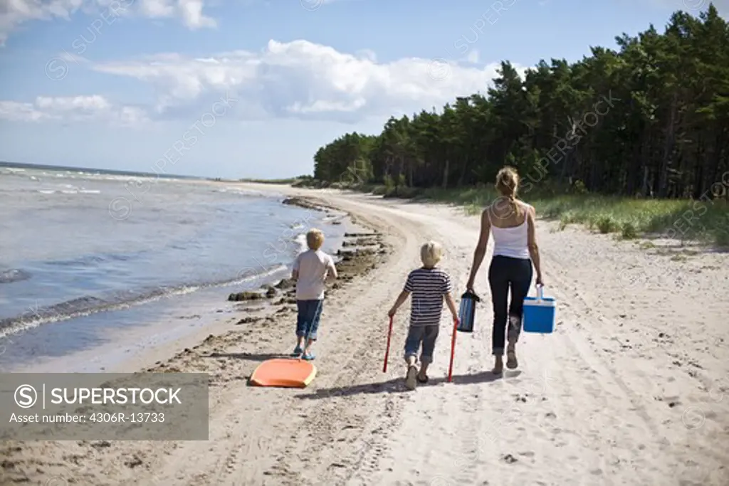 Mother and children walking on a beach, Gotland, Sweden.